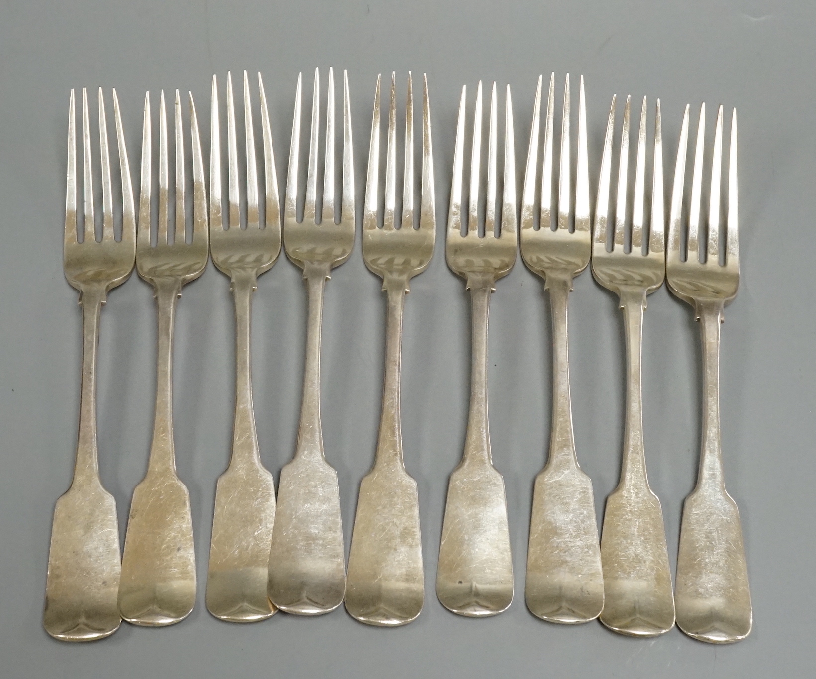 A set of nine George III Irish silver fiddle pattern table forks, Matthew West, Dublin, 1815. 21.1cm, 21.3oz.